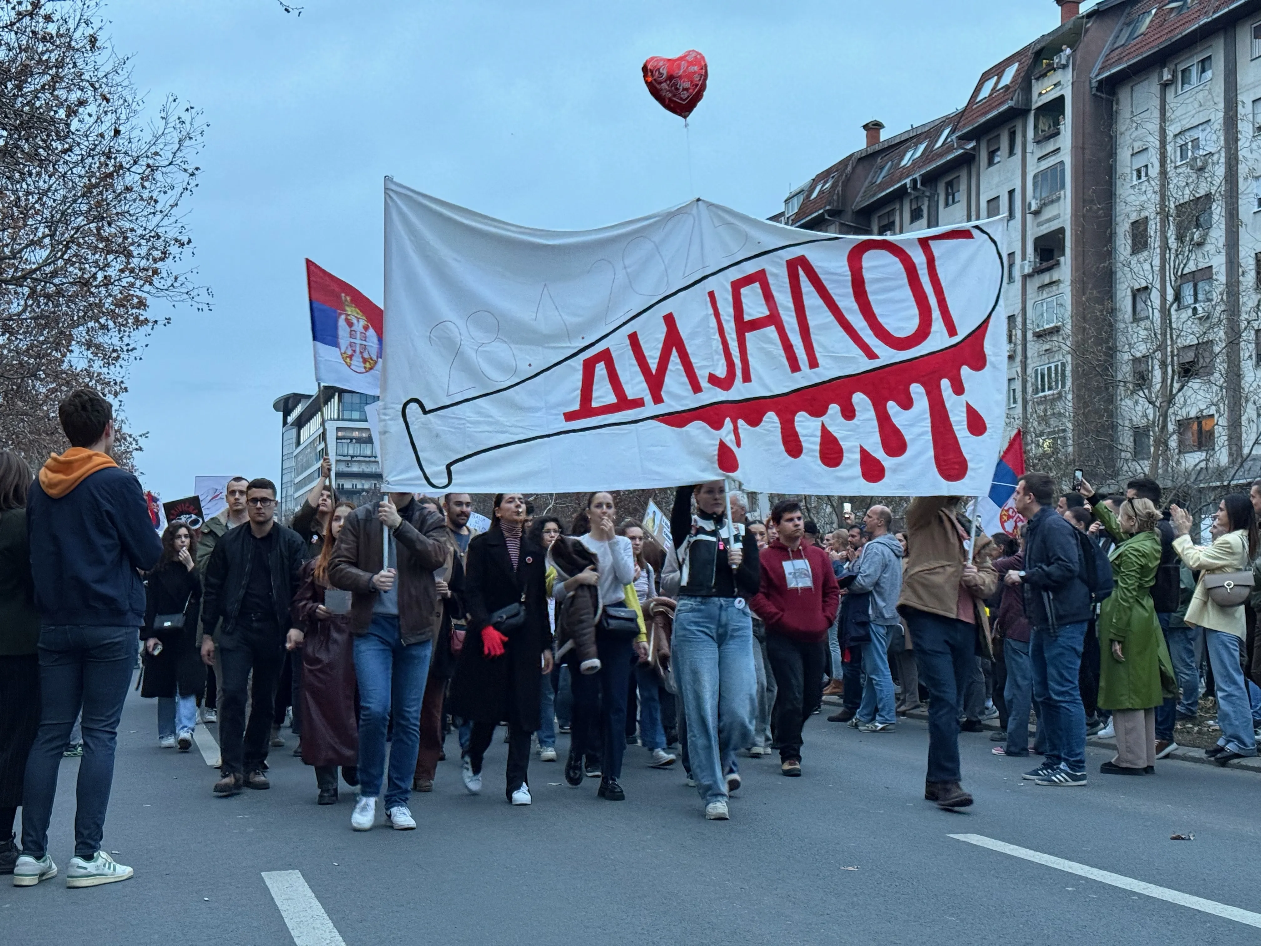 Students in Novi Sad, Serbia, marching with a banner 'DIALOGUE'